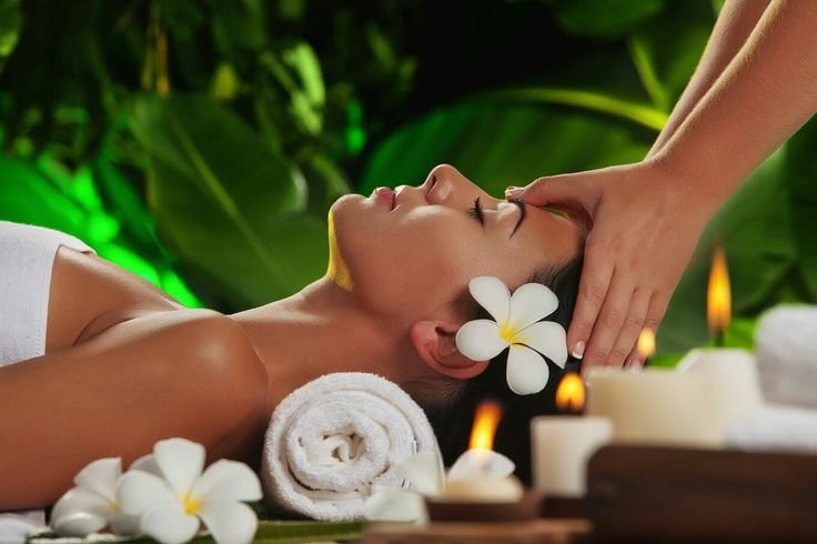 Serene spa experience with professional head massage and candlelit atmosphere.