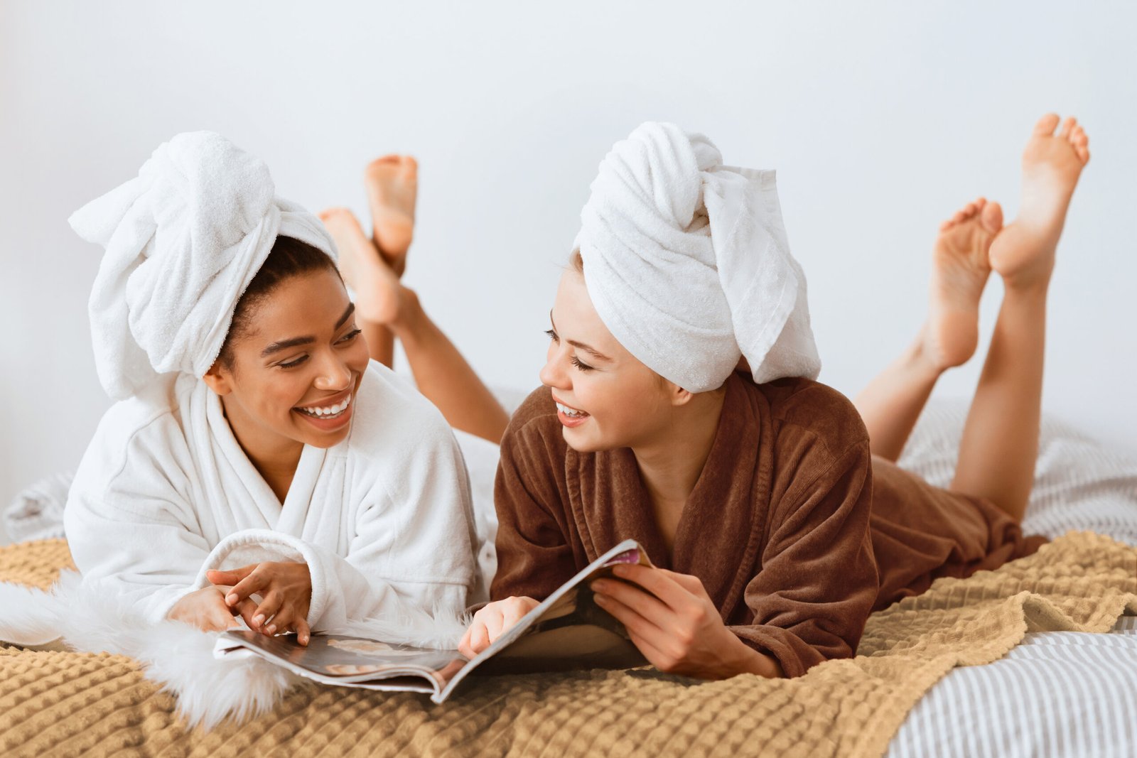 Young women in bathrobes and towels on their heads, relaxing and enjoying a spa-like atmosphere